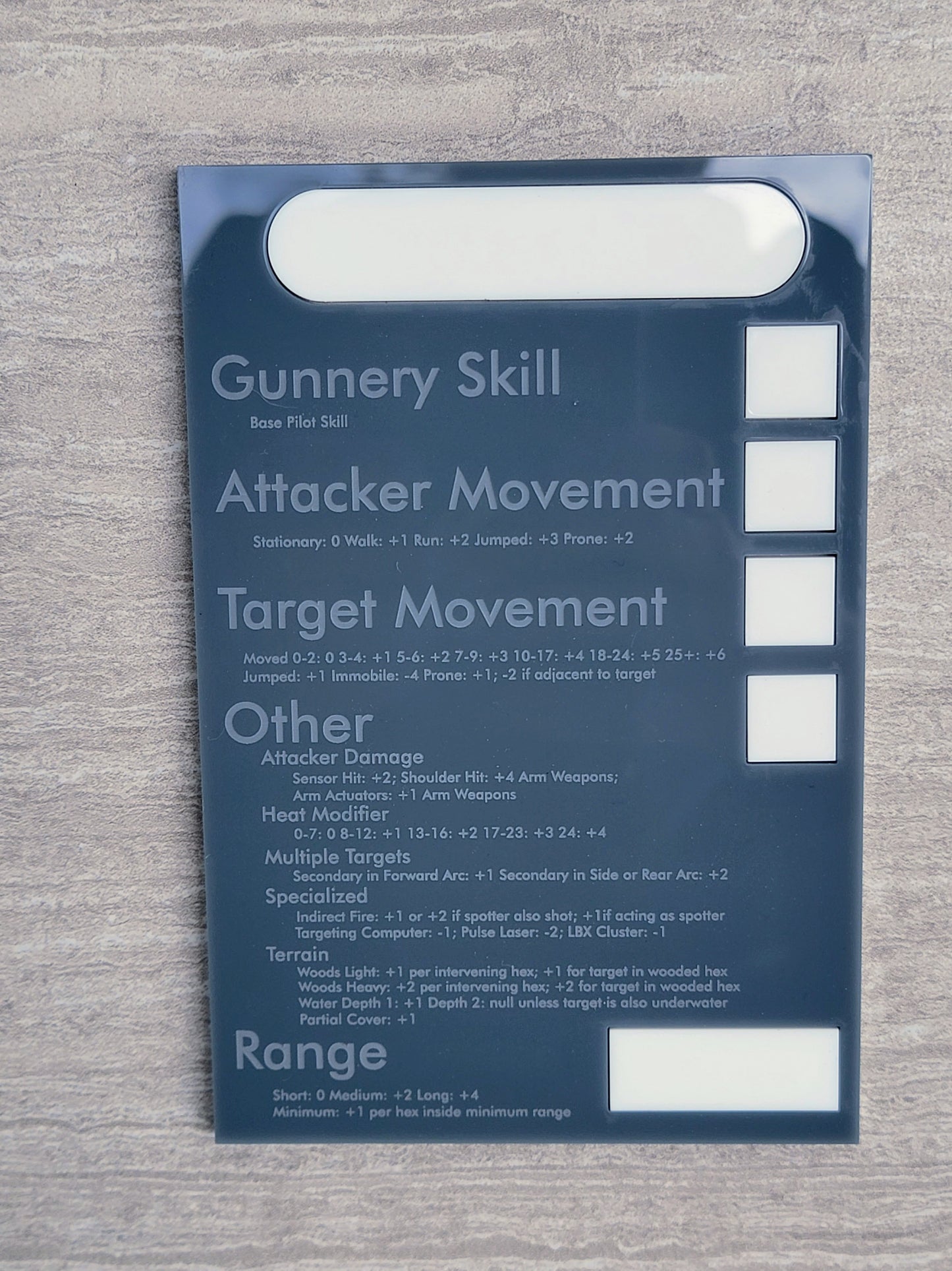 Gray acrylic battletech Calcugator on gray background