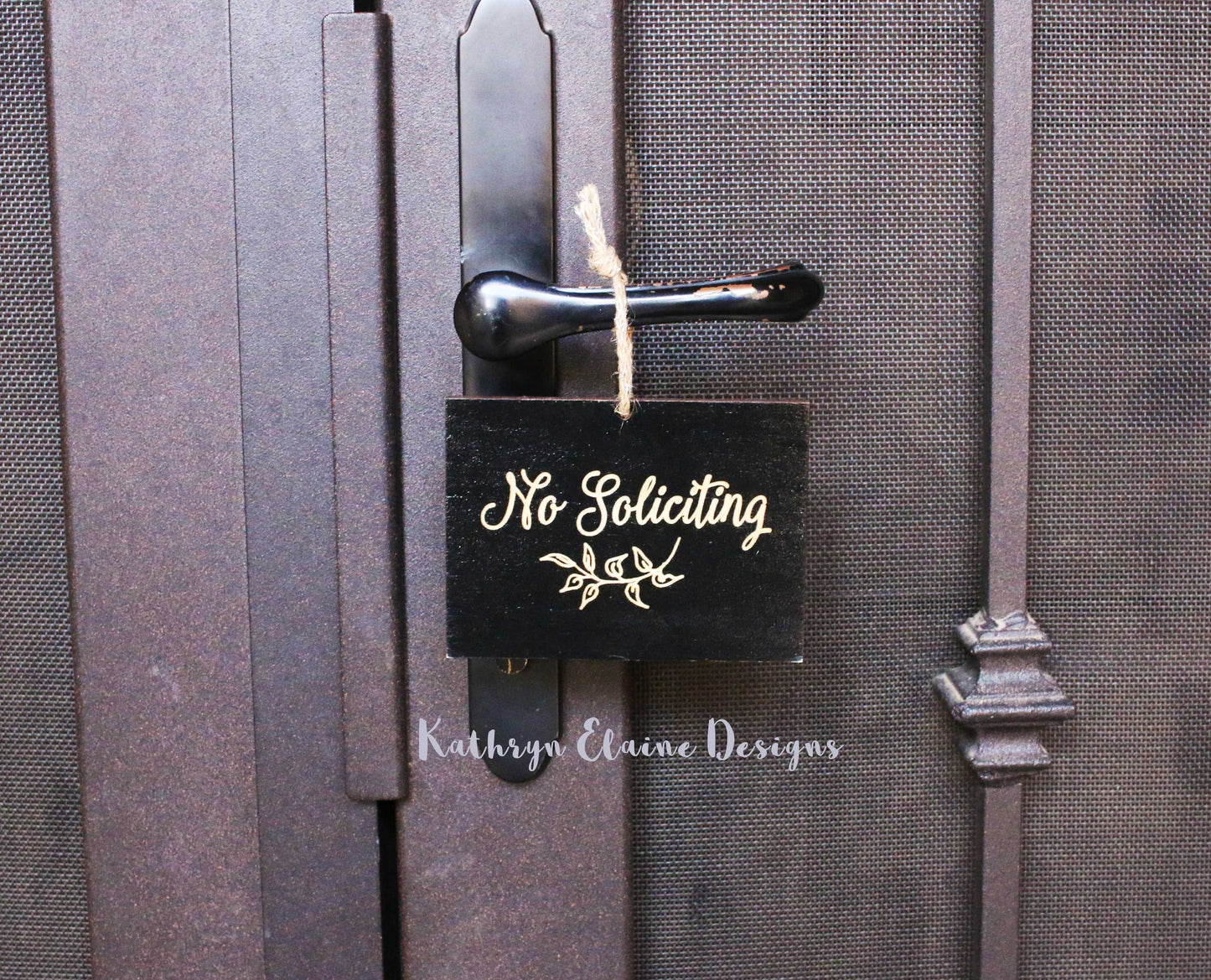 Black rectangle laser engrave no soliciting sign with leaf design and twine hanger on screen door