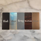 5 laminate color choices: black with white lettering, silver with black lettering, gray with white lettering, wood grain with white lettering, and bronze with gray lettering on marble background
