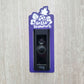 Purple laminate doorbell surround with white pineapple, leaves, and flowers and lettering saying hello summer on ring doorbell and gray background