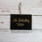 Black rectangle laser engrave no soliciting sign with leaf design and twine hanger on white wood background