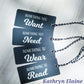 4 gift tags in black with white lettering reading something you want, something you need, something to wear, something to read on white background