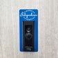 Blue laminate doorbell surround with white lettering saying Happy Independence Day and stars on ring doorbell and gray background
