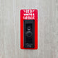 Red laminate doorbell surround with white lettering stating red, white and blessed on gray background