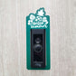Green laminate doorbell surround with white pineapple, leaves, and flowers and lettering saying hello summer on ring doorbell and gray background