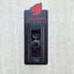 Black doorbell surround with red dragon head and lettering stating Welcome Ring for Initiative around Ring doorbell on gray background